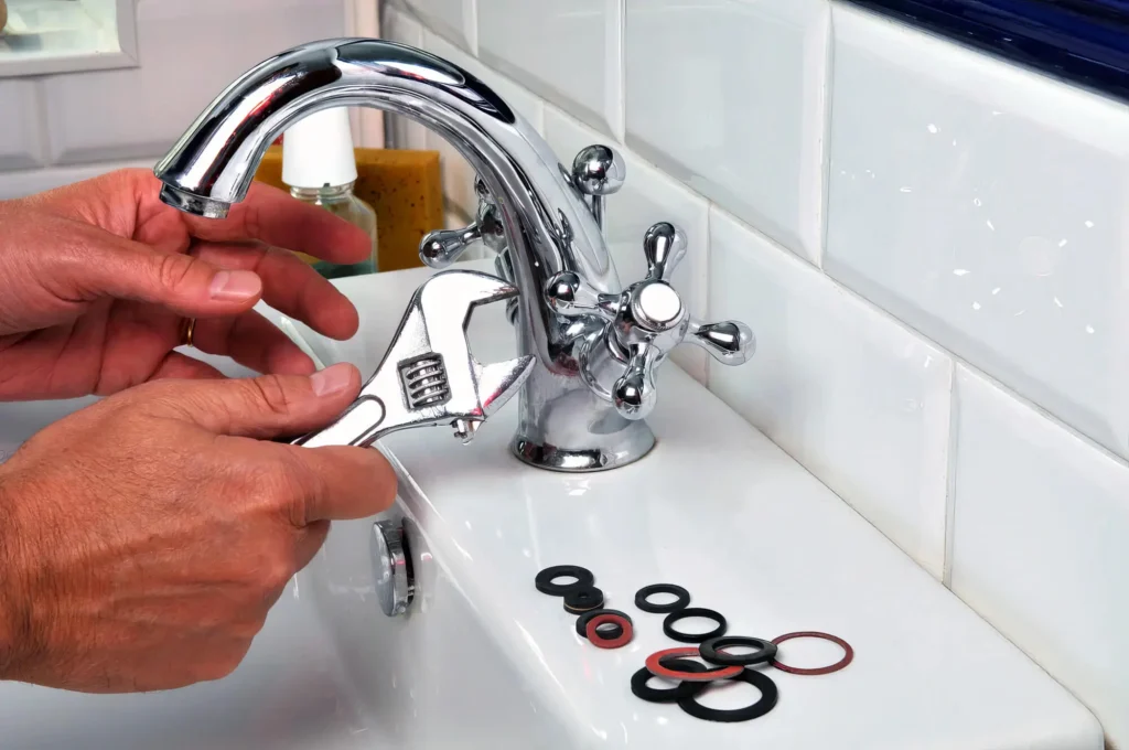 Plumber performing maintenance on a bathroom faucet in Spring Valley