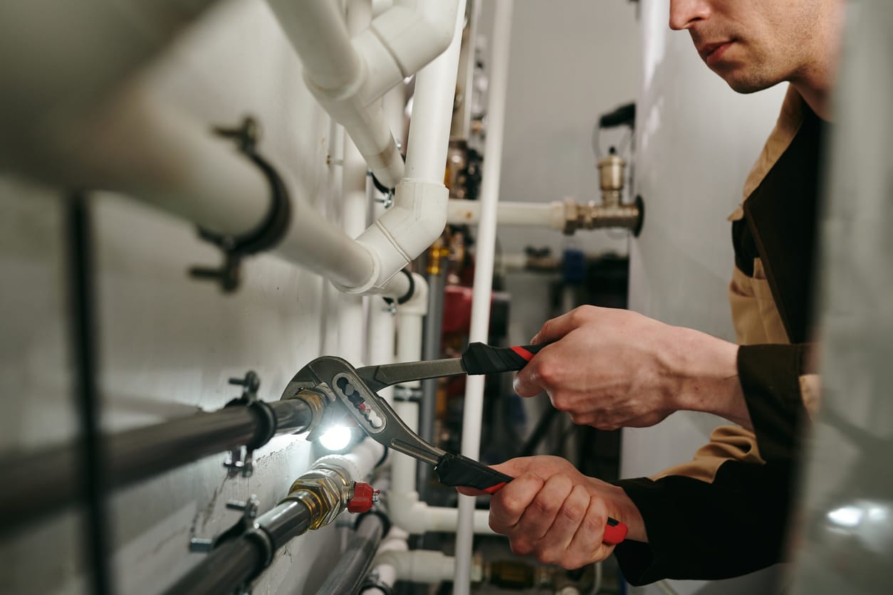 Plumbers maintaining commercial plumbing pipes in Spring Valley