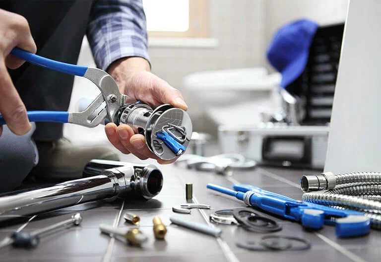 Technician repairing a plumbing fixture with professional tools in Spring Valley