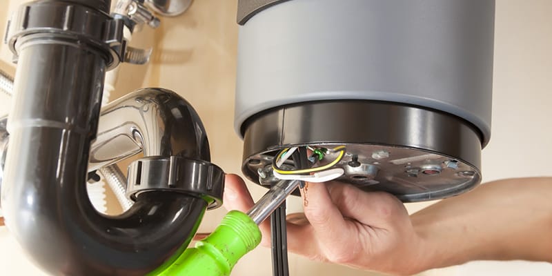 Technician repairing the heating element of a water heater in Spring Valley