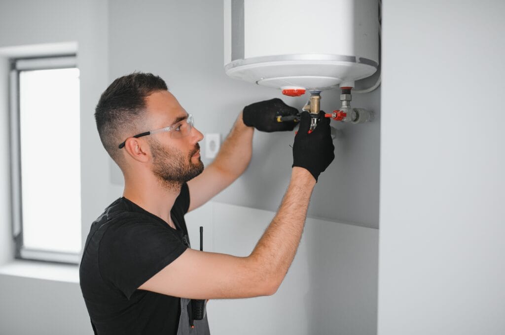 Technician performing water heater maintenance in Spring Valley