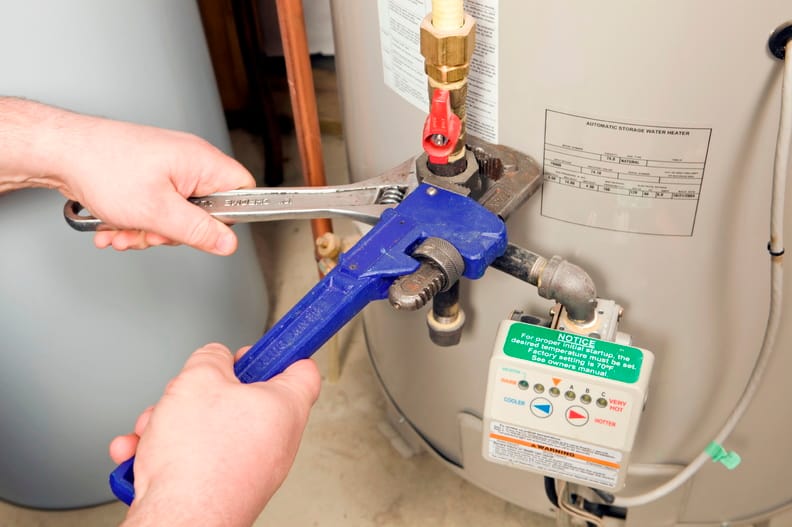 Plumber repairing a water heater valve in Spring Valley